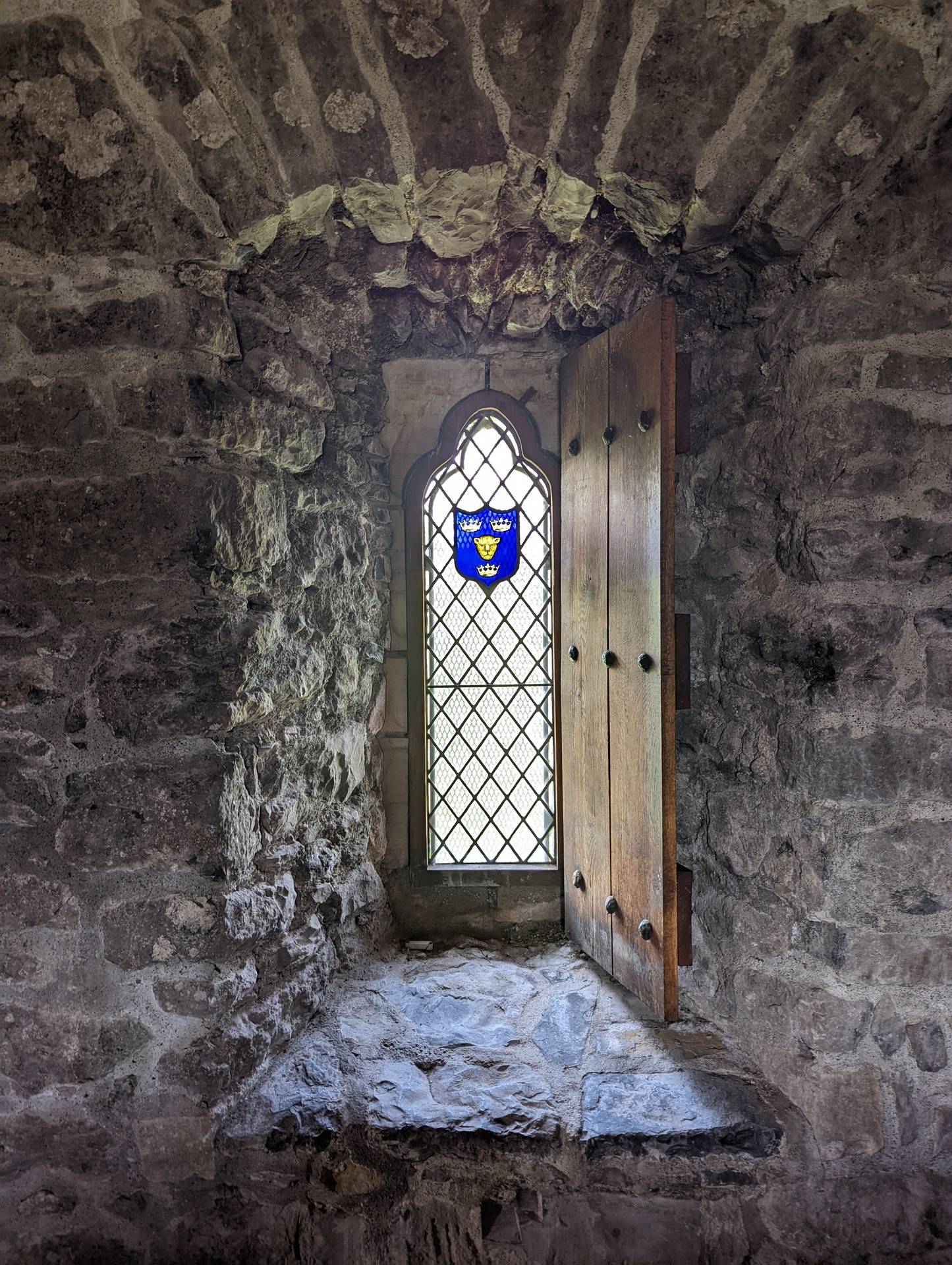 Castle window with blue coat of arms